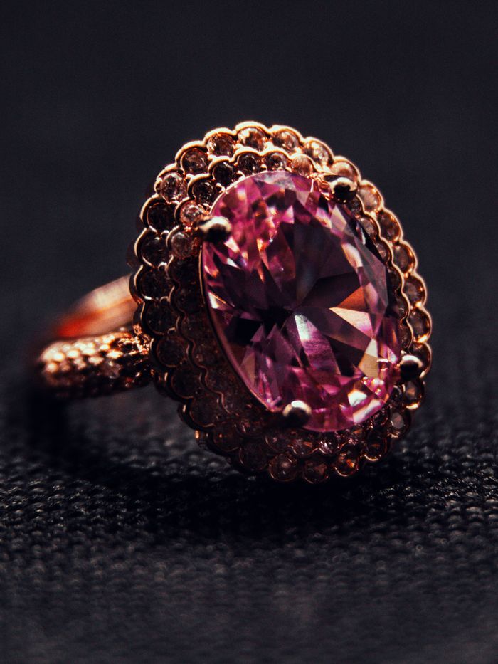 pexels photo 19132380 Close-up of a luxurious pink gemstone ring set in intricate gold detailing.