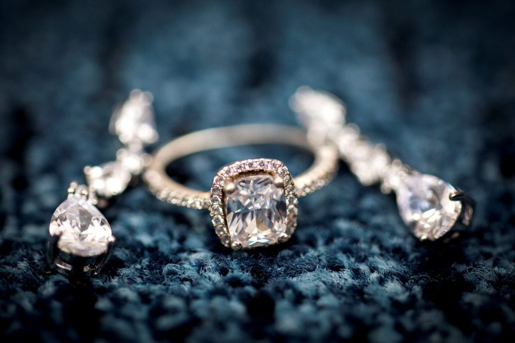 Stunning diamond ring displayed on a textured blue background, showcasing elegance and craftsmanship.
