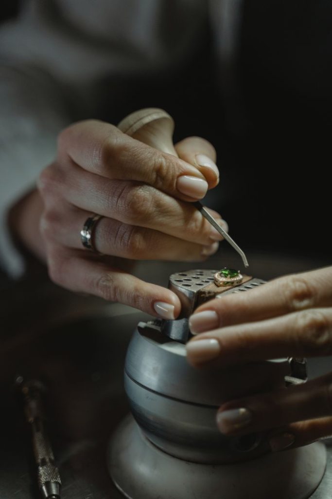pexels photo 6263157 Close-up of a jeweler skillfully crafting an emerald ring, showcasing precision and detail.